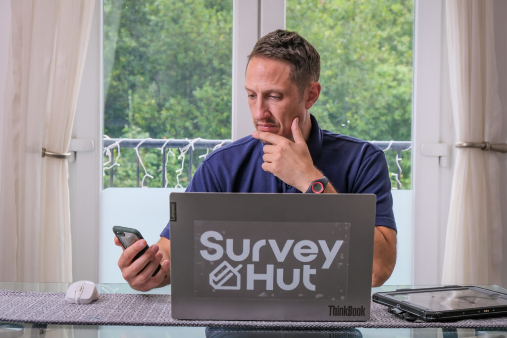 Surveyor holding business phone